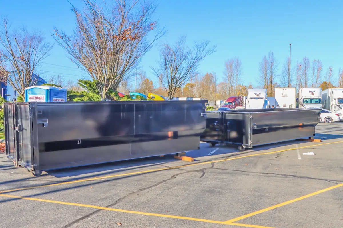 Professional dumpster rental service with roll-off container on residential driveway in Miami Shores